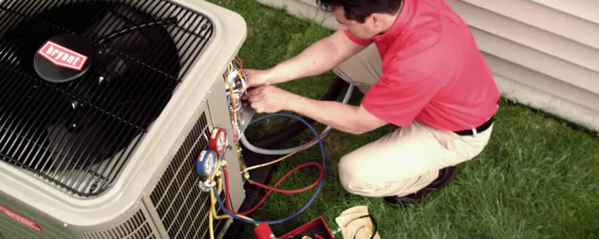 HVAC technician servicing an outdoor air conditioner unit in Tacoma, WA